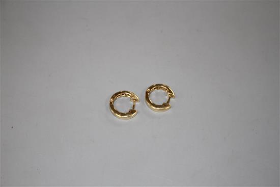 A pair of modern 750 yellow metal and seven stone baguette cut diamond set half hoop earrings, approx. 14mm, gross 4.2 grams.